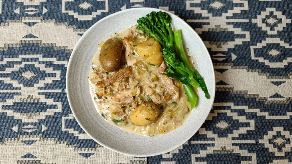 Photograph of Creamy tarragon chicken with bacon, leeks and potatoes.