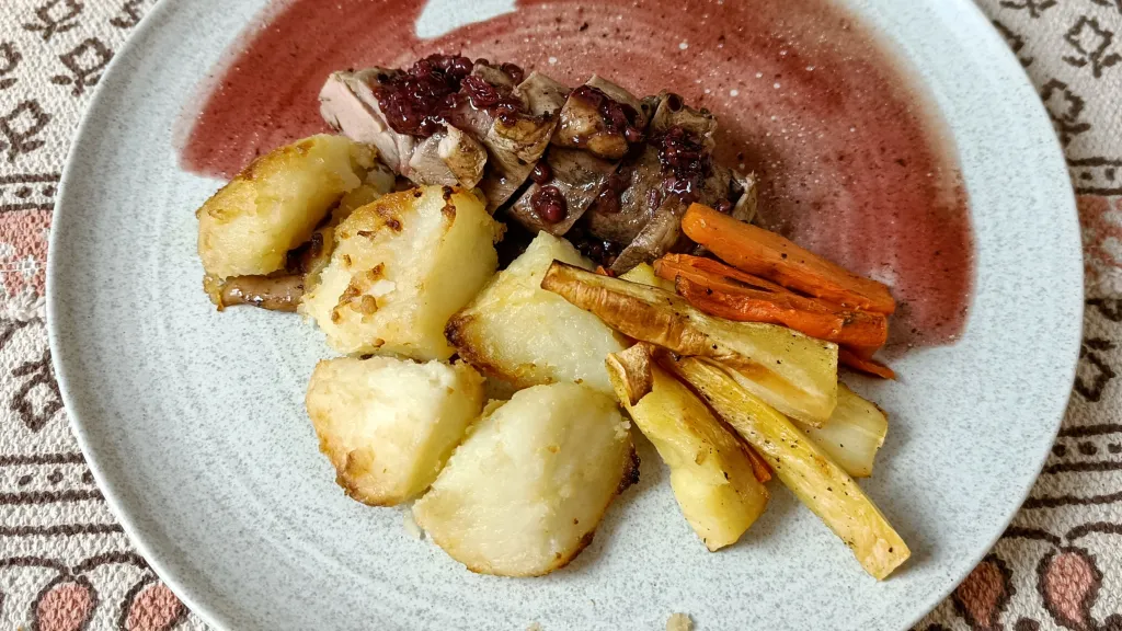 Photograph of Duck breasts with juniper, blackberry and port sauce.