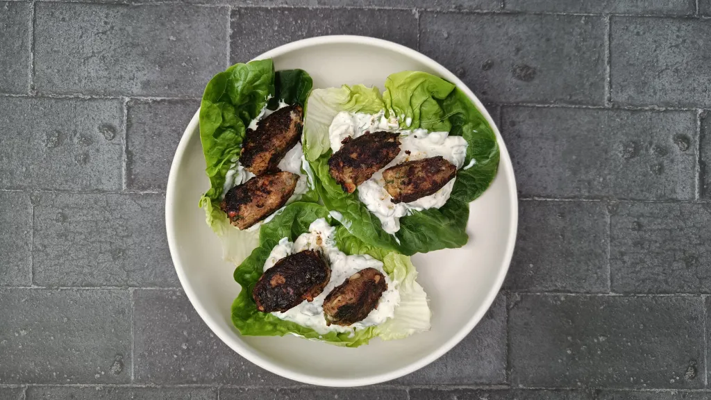 Photograph of Harissa kofta lettuce cups with preserved lemon yogurt.