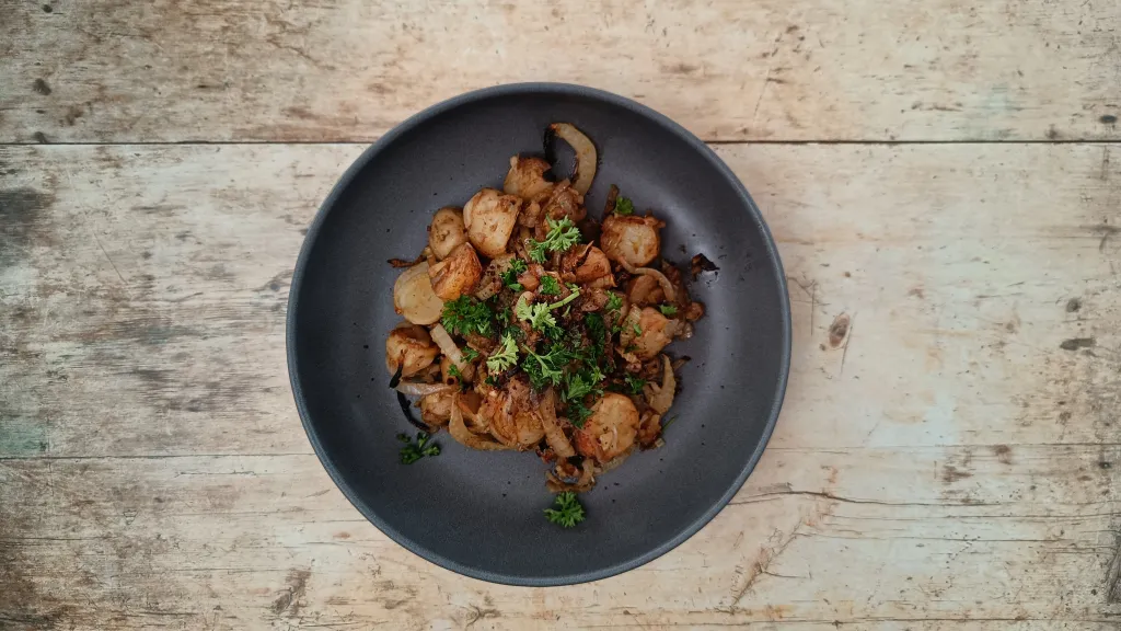 Photograph of Roasted potato, onion and fennel tagine with sumac and balsamic vinegar.
