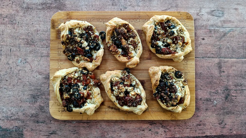 Photograph of Za’atar, tomato, olive & feta pastries.